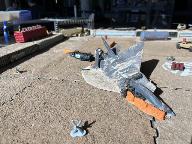 The wreck of a jet fighter in the desert arena