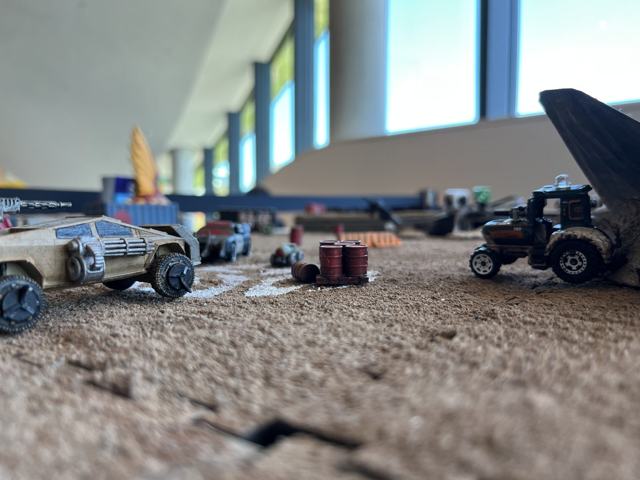 Low-angle view of toy cars racing across the arena