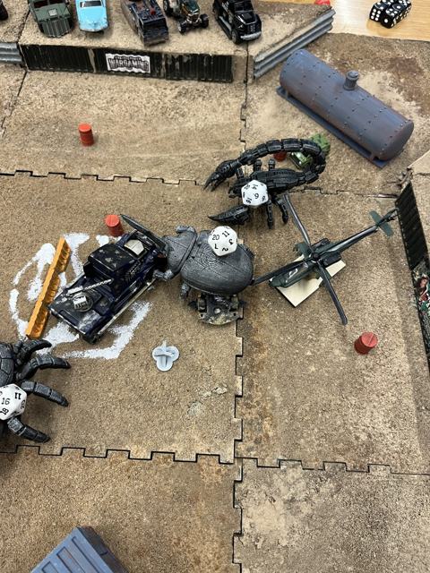 Spiders swarming a helicopter in the middle of the arena